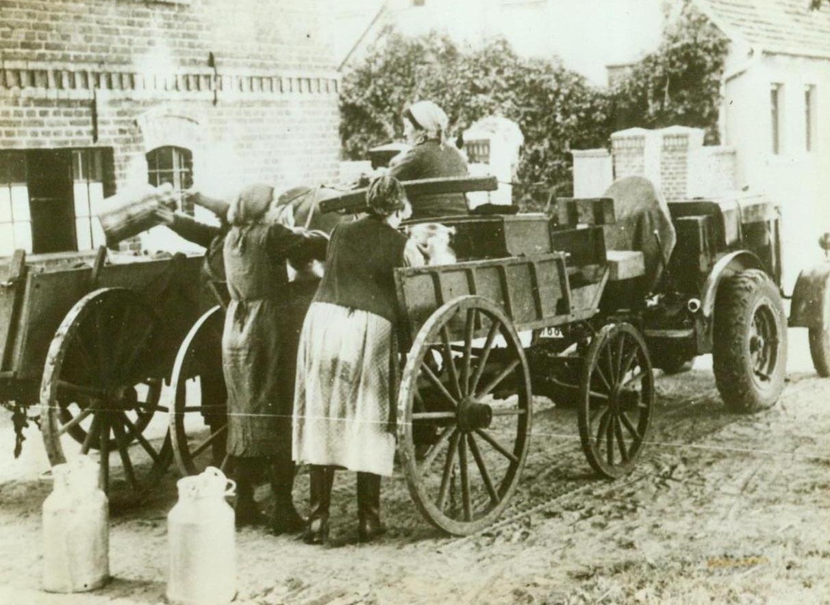 WOMEN TAKE OVER IN GERMANY, TOO, 5/22/1943.  SOMEWHERE IN GERMANY – In Germany, as in every warring country, the women have taken over men’s jobs. Although Hitler would keep his women in the kitchen in peacetime, he has no objection to recruiting their labor now, to further his war. German farm women are shown loading a milk truck in this photo, which was obtained through a neutral source Credit Line (ACME);