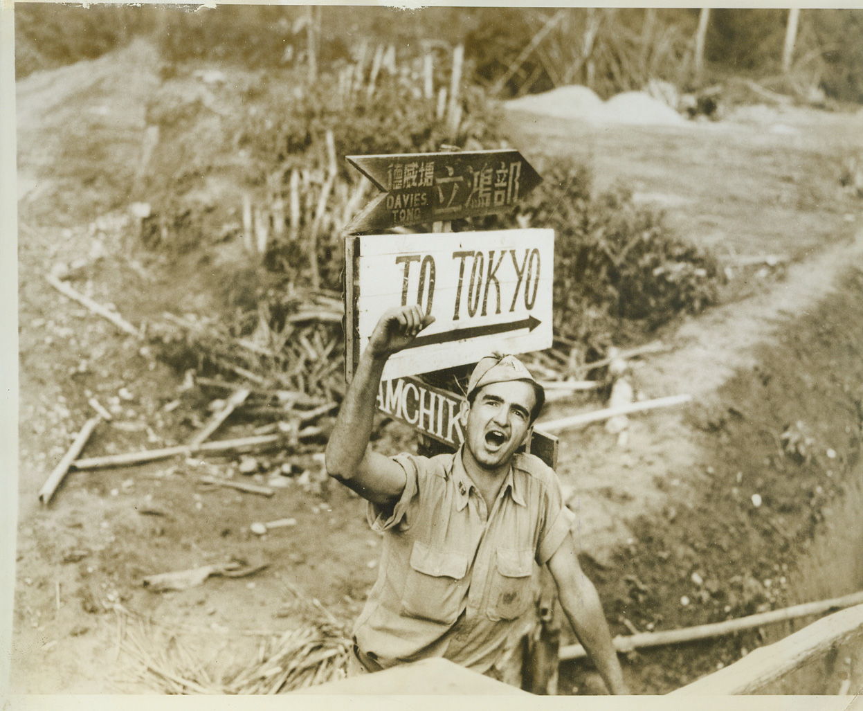 New Burma Road - Shortcut to Tokyo, 9/28/1943. ASSAM, India - Captain John E. Moyer, of Tuskegee, Ala., one of many U.S. Army Engineers working on a new branch of the Burma Road, points out the direction which United Nations moving over the road, will eventually take - to Tokyo. The road starts at Assam, will cross the North Burma border and on into Central Burma, where it will connect with the Old Burma road, now blocked by Jap occupation. The new road was begun last December.;
