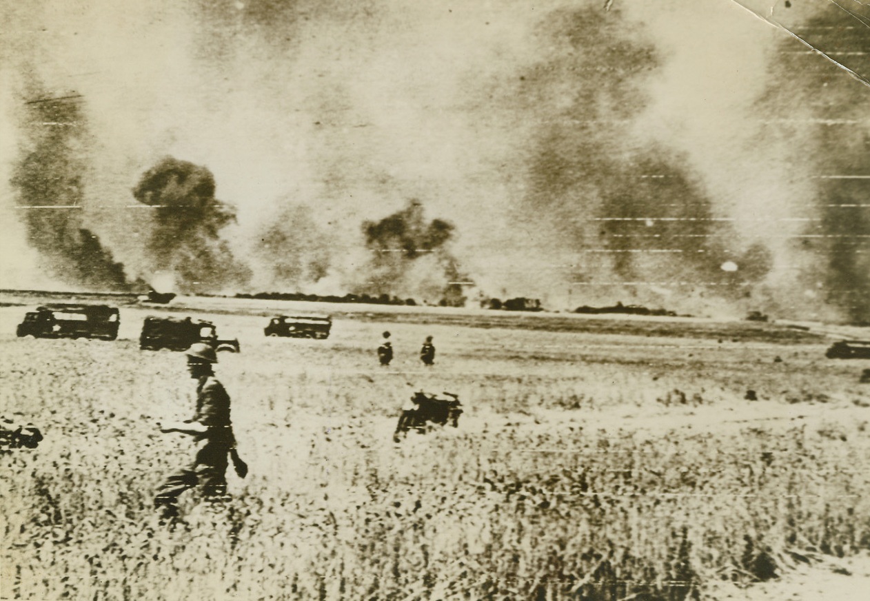 AIR SUPPORT FOR ADVANCING ALLIES, 8/12/1944. CAEN, FRANCE – Bombs burst on German positions South of Caen as fortresses attack after the great RAF raids which softened up the enemy for attack by British and Canadian forces advancing on land. Credit: British official photo via Signal Corps radio telephoto from Acme;